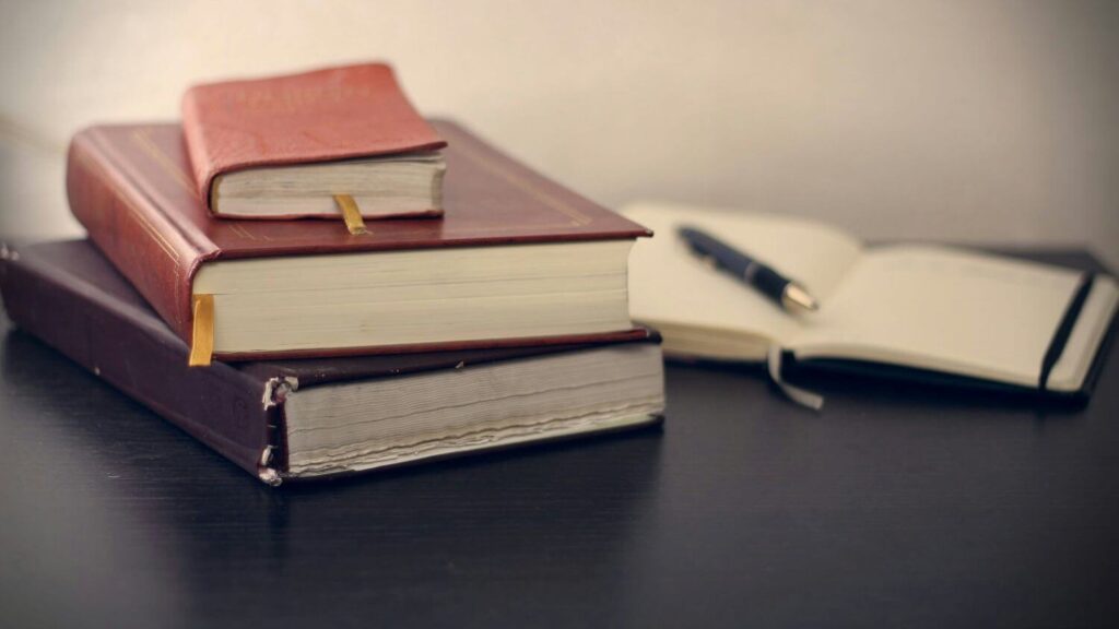 stack of books and notes while writing a phd thesis