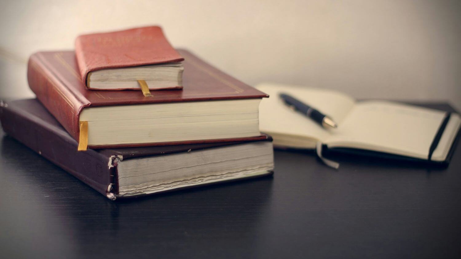 stack of books and notes while writing a phd thesis