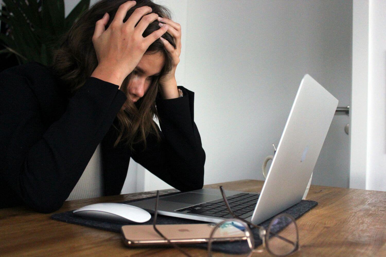 woman at desk facing burnout, PhD proposal sample writing