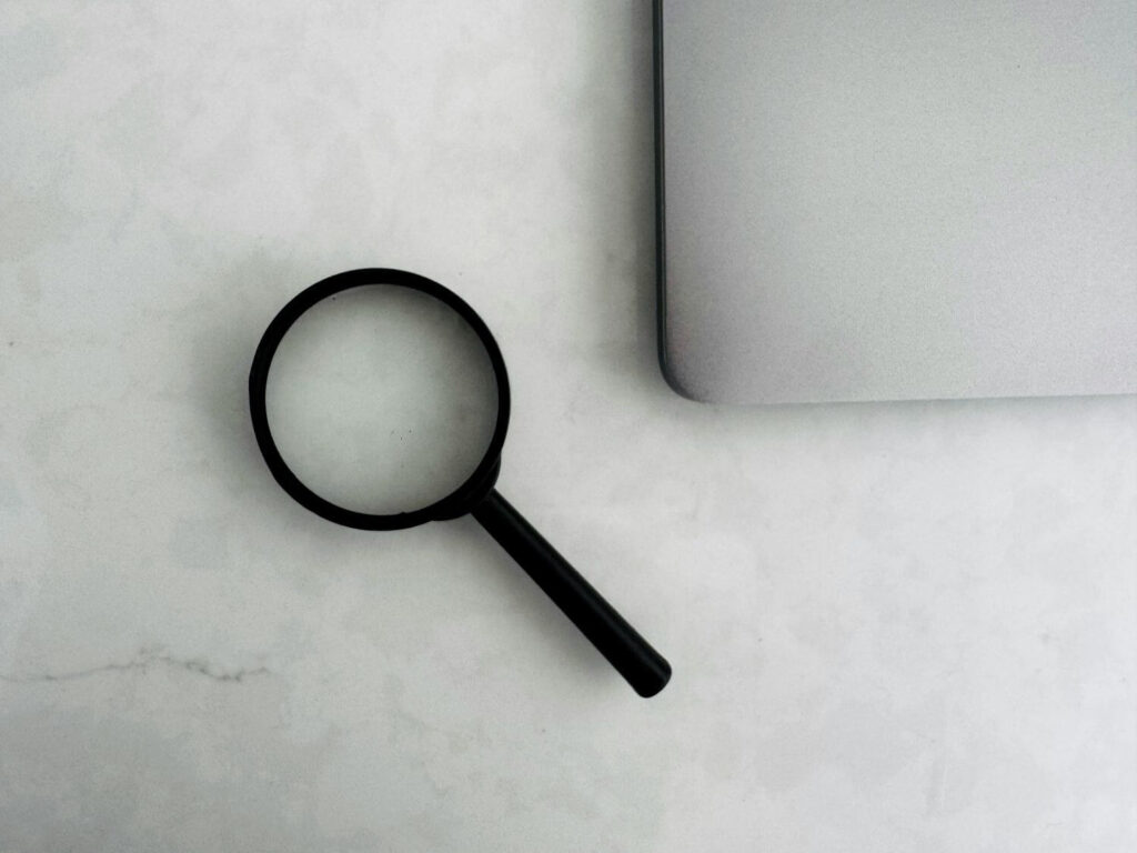 magnifying glass on desk looking for the best journal for PhD publication