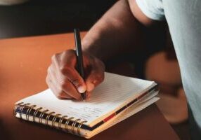 man writing phd by hand