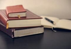 stack of books and notes while writing a phd thesis