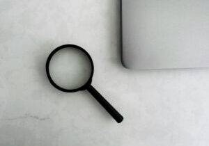 magnifying glass on desk looking for the best journal for PhD publication